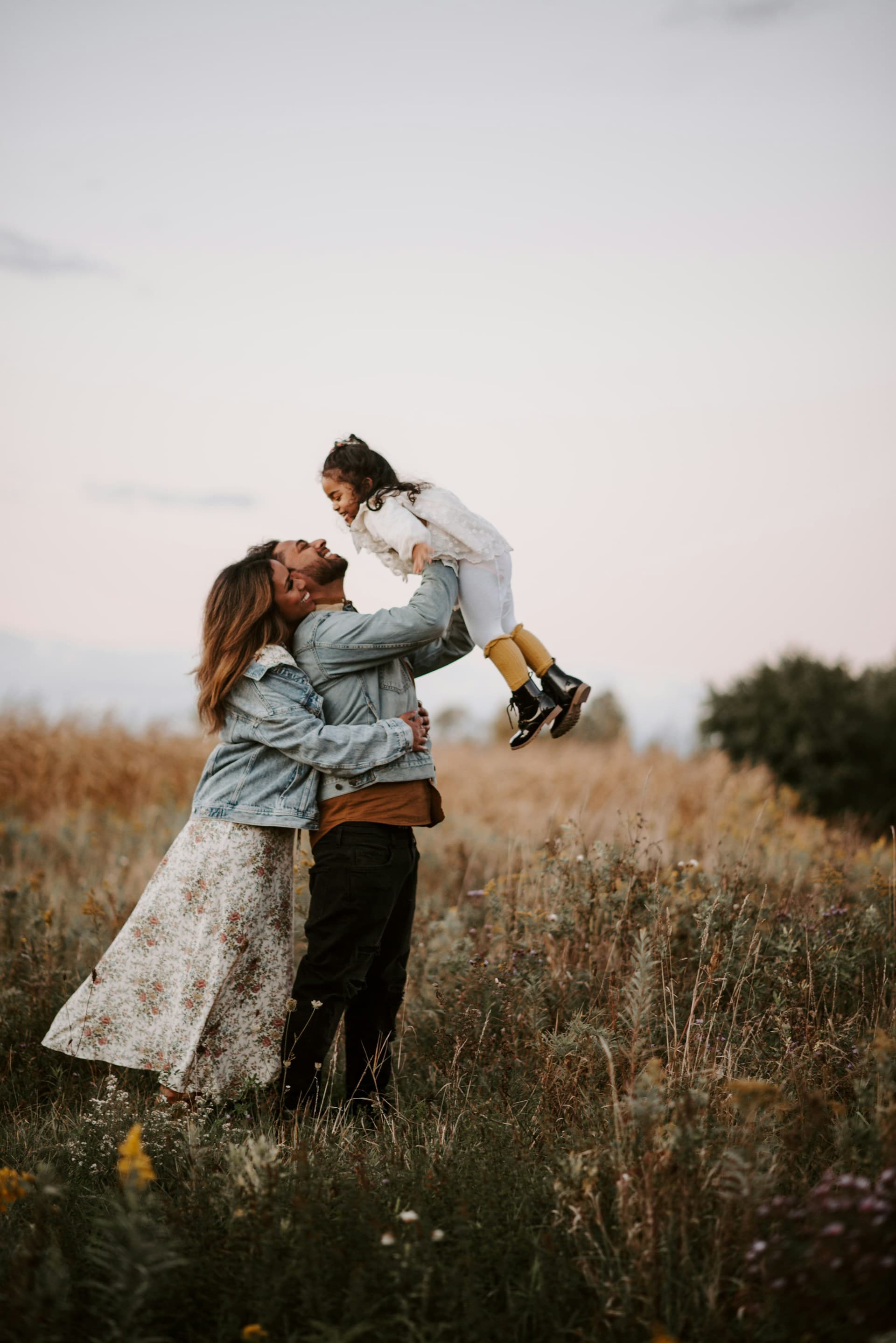A family enjoying a moment together in a green field